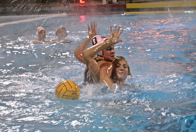 Junior Taylor Hammil, left, blocks San Ramon Valley High School player in NCS semifinals. The women’s water polo team’s great season came to an end after an 18-3 loss in this game. 