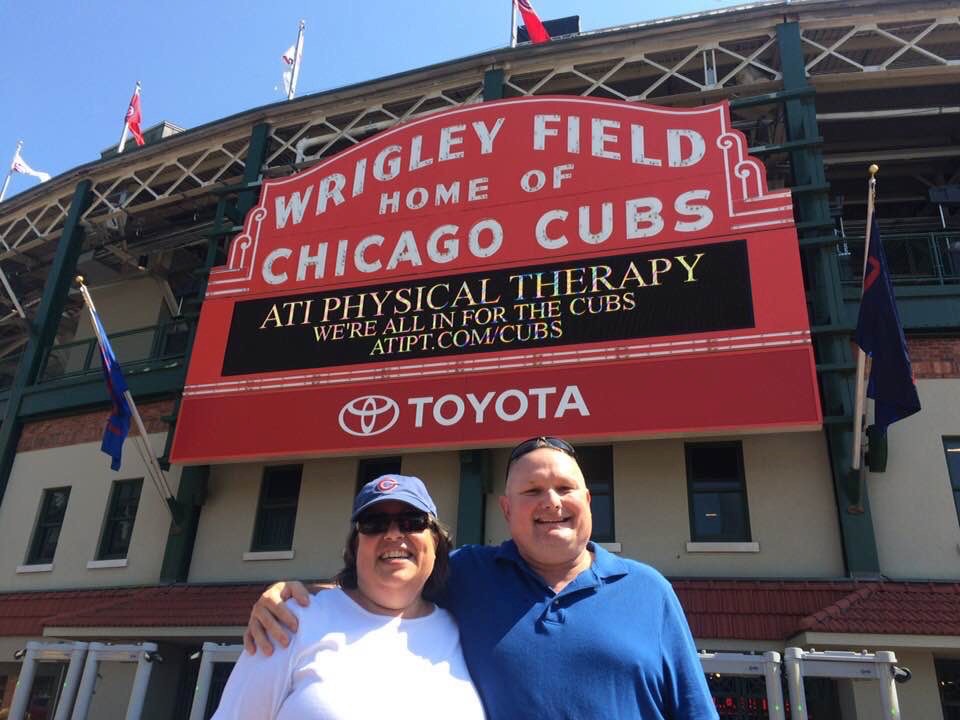 Rae Anne Crandall, left, and her husband, Jim Crandall,  pose in front of Wrigley Field, home of the Chicago Cubs.