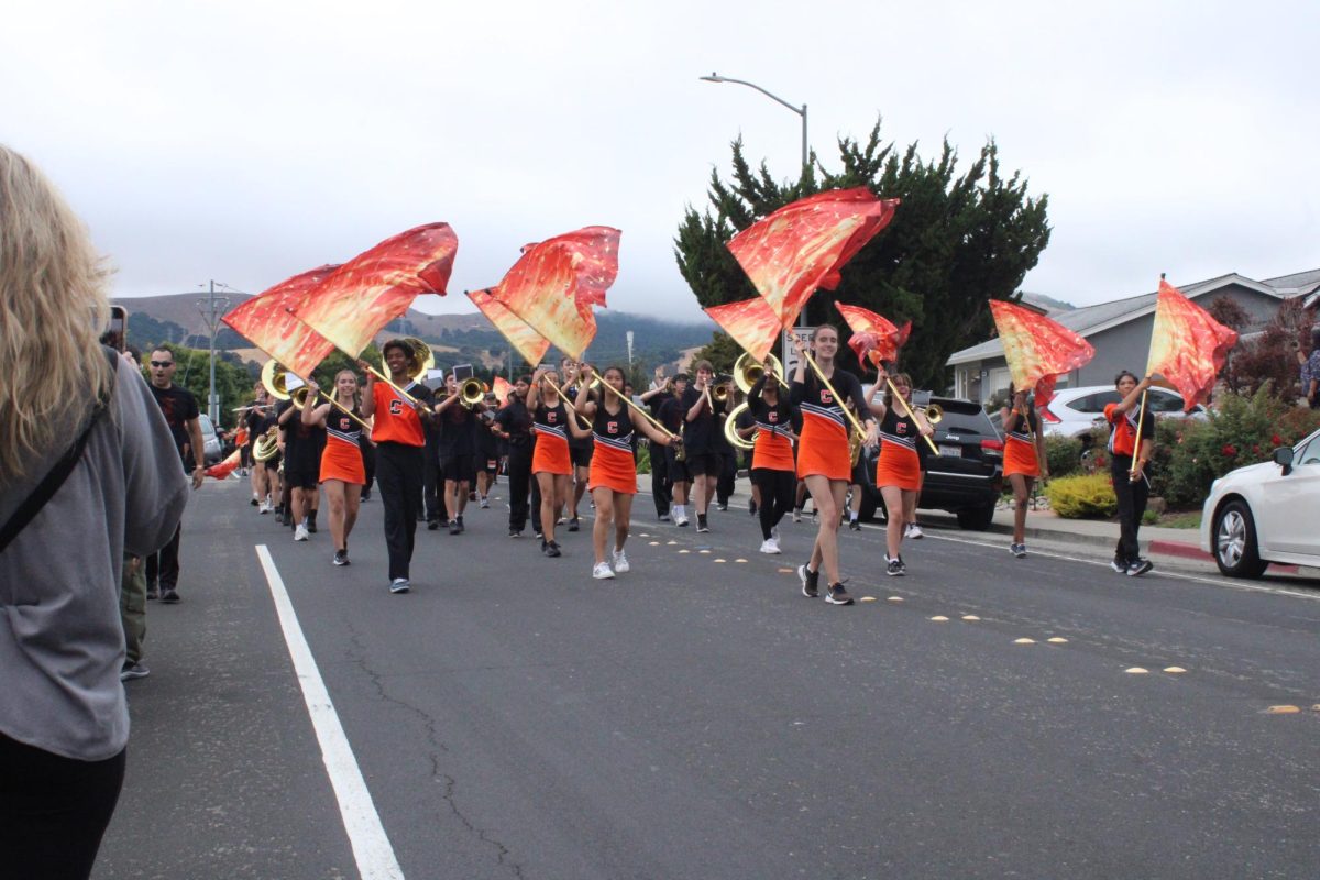 Cal High colorguard marches down Pine Valley Road during the 2023 Homecoming parade.