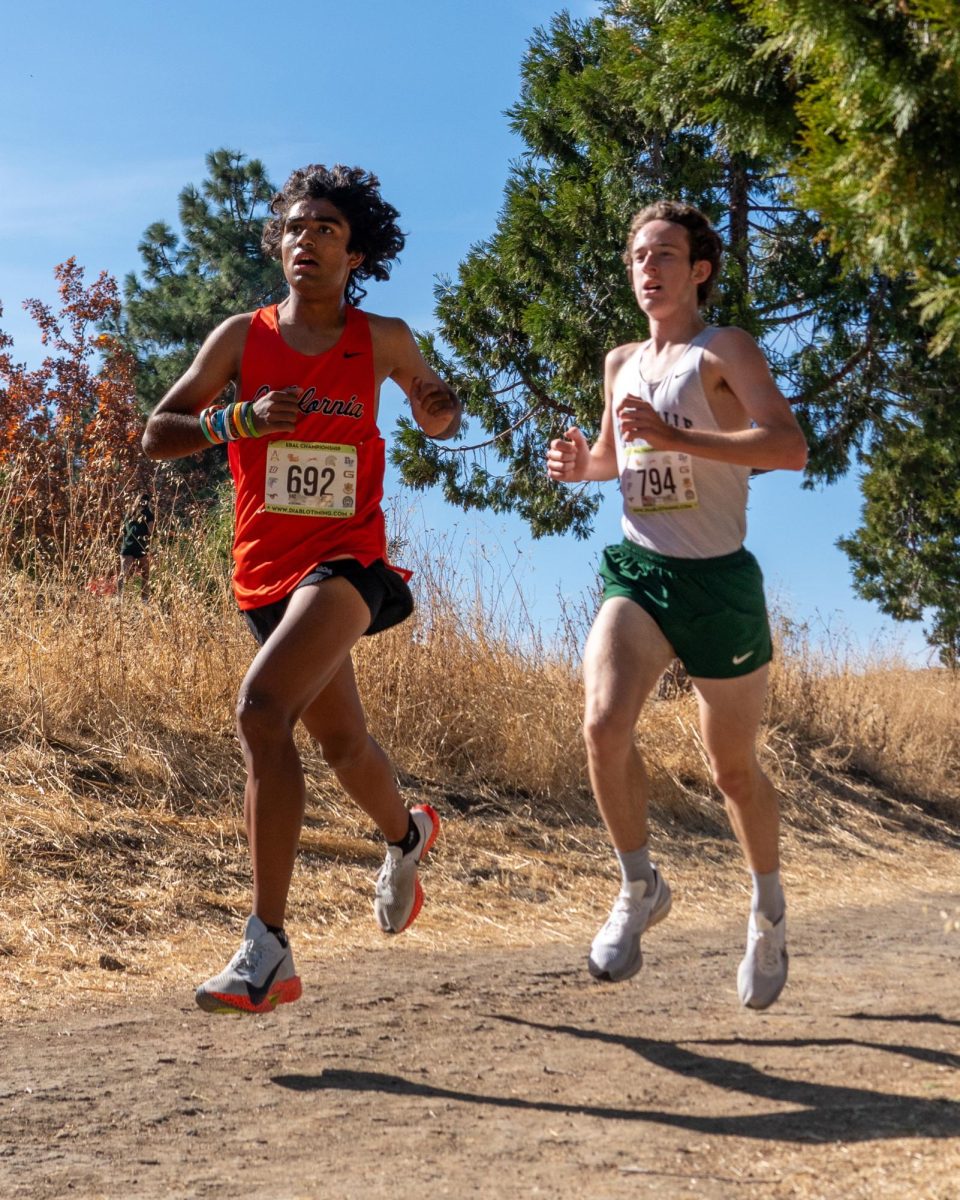 Senior Eshaan Hussain, left, races toward the finish line at the EBAL Championships on Nov. 9. Hussain, who earned All-EBAL honors, went on to place second at the NCS Championships and 14th at the State Finals. It was the best finish at state in Cal’s history.