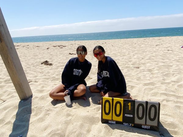 Seniors Sophia Bonifacio, left, and Anne Yamada pose behind their scoreboard before a match. They both will be trying out for Cal’s beach volleyball team this season.