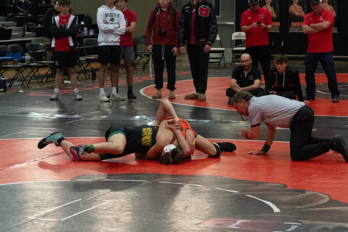 Cal sophomore Jacob Vass tries to pin a San Ramon Valley opponent during the Battle of the Axe on Jan. 29.  Cal placed second behind Monte Vista in the district-wide meet.