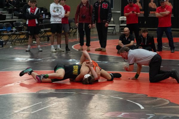 Cal sophomore Jacob Vass tries to pin a San Ramon Valley opponent during the Battle of the Axe on Jan. 29.  Cal placed second behind Monte Vista in the district-wide meet.